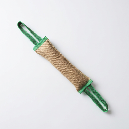 Woven dog tug toy with green loop handles